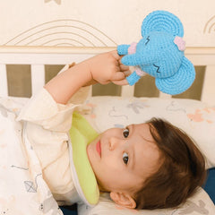 Handmade Elephant Crochet Rattle Resting on a Soft Surface