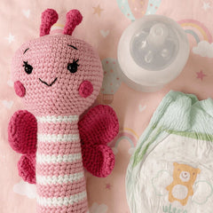 Handmade Butterfly Crochet Rattle Resting on a Soft Surface