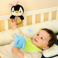 Baby Holding Happy Matty Penguin Crochet Rattle