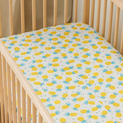 Happy Matty Pineapple Print Crib Sheet Spread on a Baby