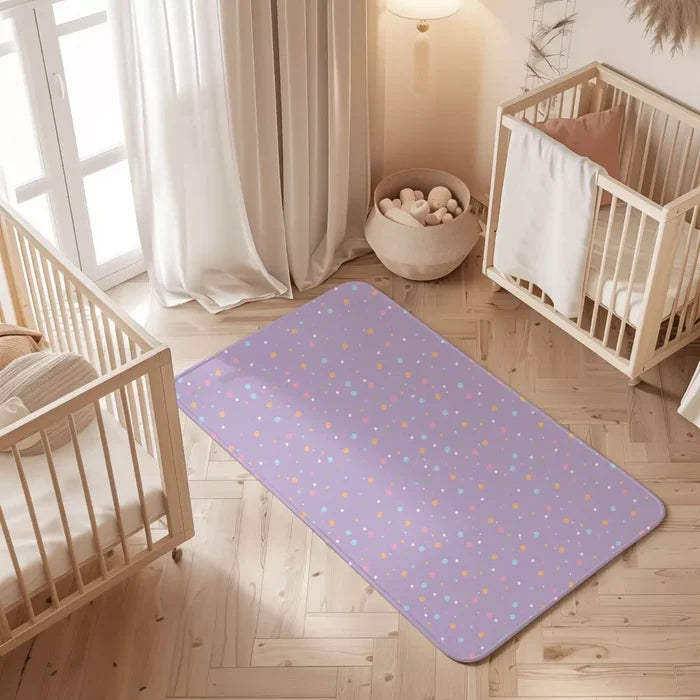 Polka Dots print waterproof baby dry sheet laid flat on a bed