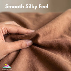 A close-up of a person's hand stretching and pulling a brown fabric to demonstrate its smooth, silky texture. White text at the top reads 'Smooth Silky Feel' and a 'Happy Matty' logo is visible in the bottom-left corner.
