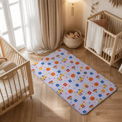 ABC print waterproof baby dry sheet laid flat on a bed