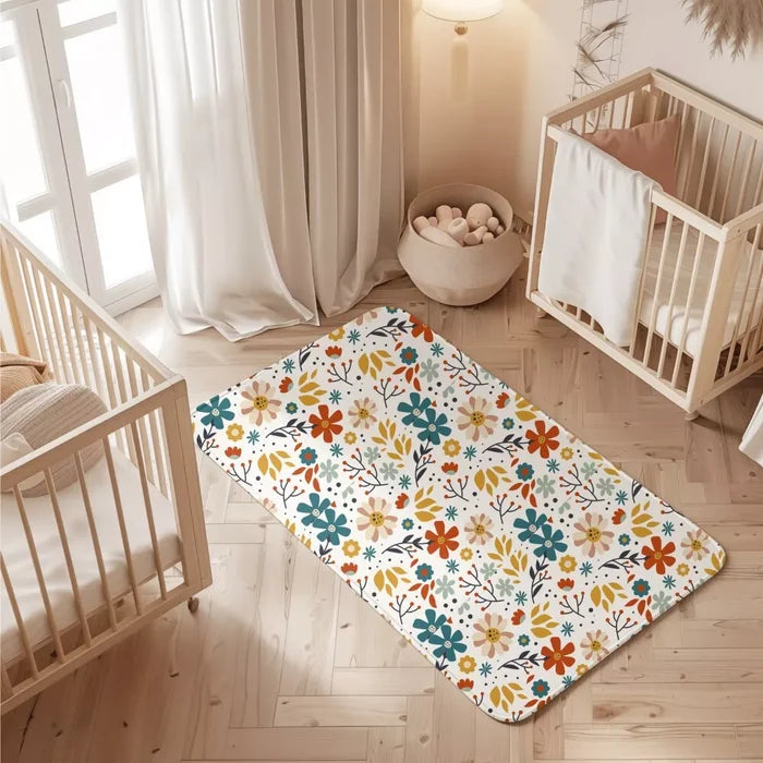 Floral print waterproof baby dry sheet laid flat on a bed