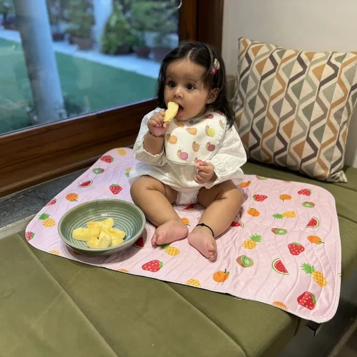 Fruit print waterproof baby dry sheet laid flat on a bed