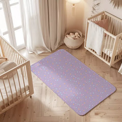 Polka Dots print waterproof baby dry sheet laid flat on a bed