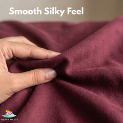 A close-up of a hand stretching and folding a smooth, burgundy fabric with the text 'Smooth Silky Feel' at the top and a 'Happy Matty' logo in the bottom-left corner.