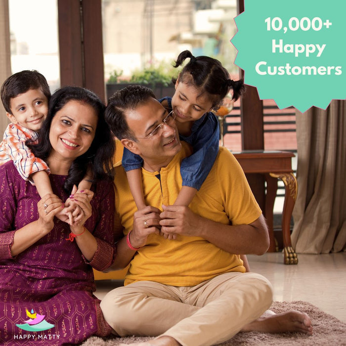 A family of four sitting together in a home interior, with a teal promotional badge in the top right reading '10,000+ Happy Customers' and a small 'Happy Matty' logo at the bottom left. The central adult male wears a yellow polo shirt and beige pants while holding a young girl on his shoulders, and the other family members are visible around them.
